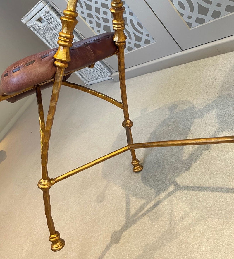 A Mark Brazier Jones "Tally Ho" chair a sculptural chair upholstered in a tan leather, with leather reigns, straps and steel stirrups on a stylised gilt wrought iron frame