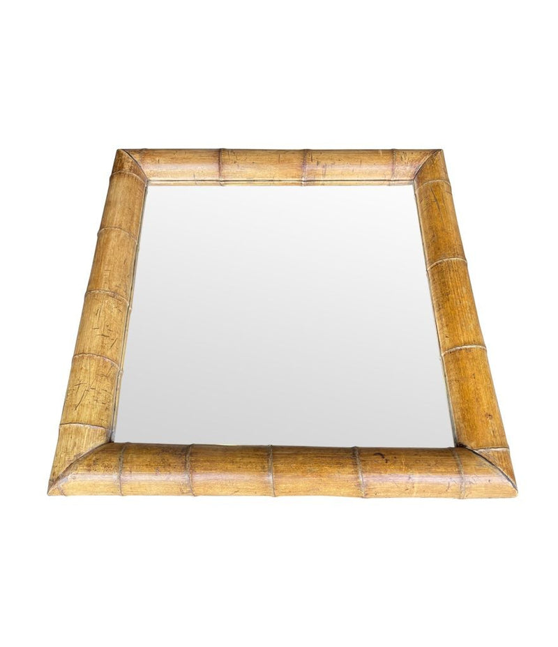 A large square mirror with a thick bamboo frame