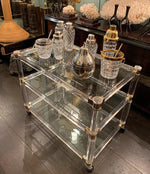 1970S LUCITE AND BRASS BAR TROLLEY WITH 3 GLASS SHELVES AND ORIGINAL CASTORS