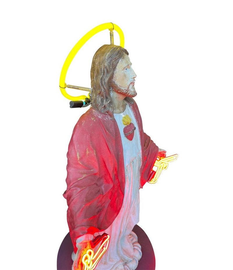 A fantastic original Chris Bracey neon art sculpture of Jesus with neon guns, halo and title on the base “I'll Be Back"