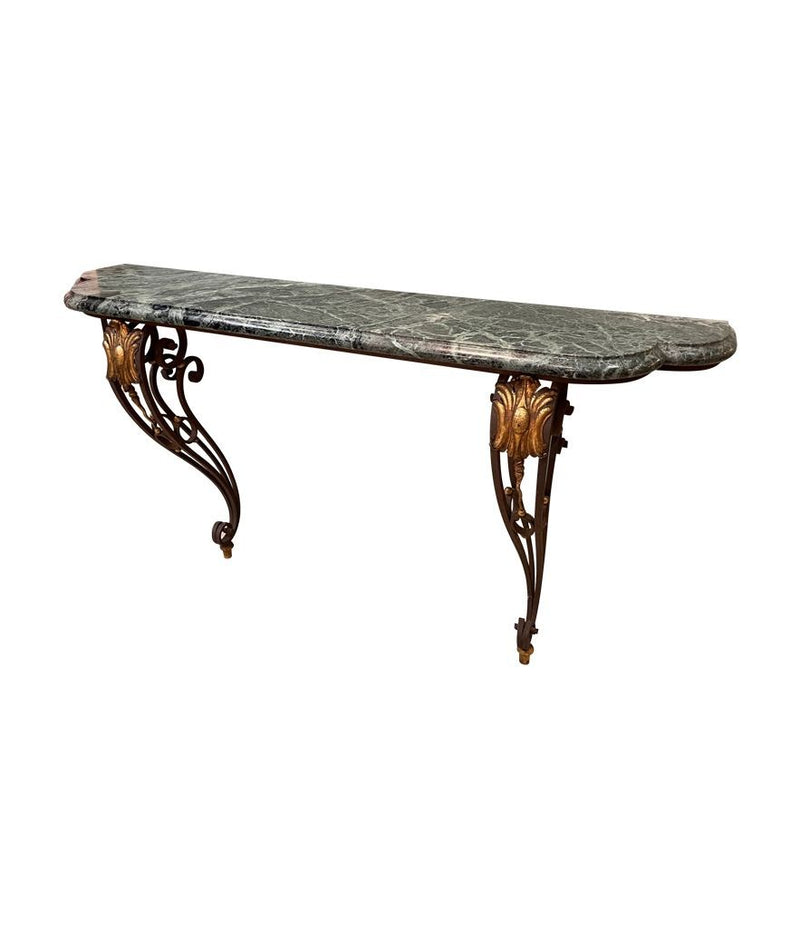 An Art Deco wrought iron gilded console table with green marble top in the style of Gilbert Poillerat