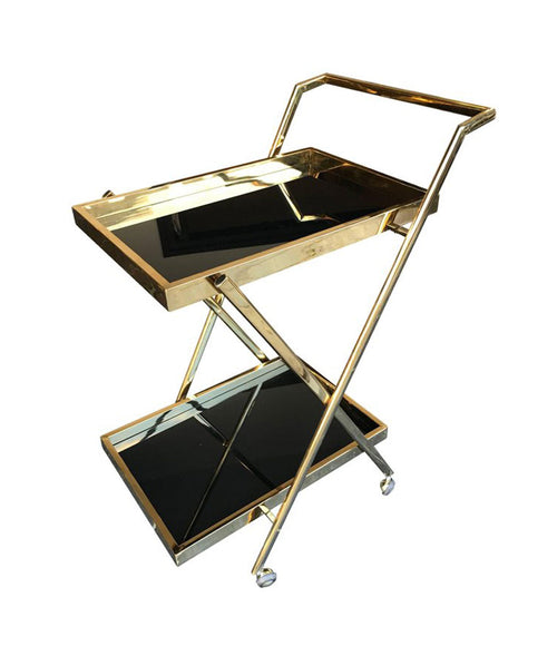 A BRASS BAR TROLLEY WITH BLACK GLASS SHELVES