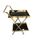 A BRASS BAR TROLLEY WITH BLACK GLASS SHELVES
