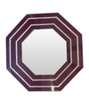 A 1970s octagonal mirror by Jean Claude Mahey with brass inlay frame