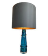 PAIR OF ORREFORS TURQUOISE GLASS LAMPS WITH BRASS FITTINGS AND BESPOKE SHADES