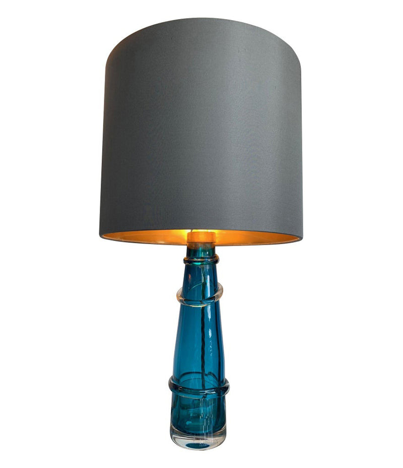 PAIR OF ORREFORS TURQUOISE GLASS LAMPS WITH BRASS FITTINGS AND BESPOKE SHADES